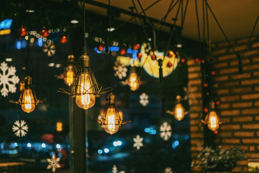 Warm and festive cafe ambiance with hanging bulbs and snowflake decorations. Cafes in Kochi with Good Ambience.